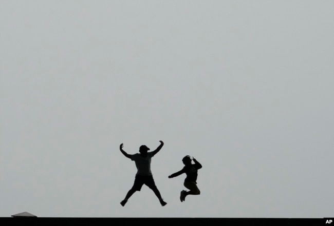 FILE - Children jump in the air at the National Museum of Korea in Seoul, South Korea, Wednesday, Sept. 20, 2023. (AP Photo/Ahn Young-joon)