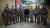 Ukraine's President Volodymyr Zelenskyy, center, and his nation's armed forces chief, General Oleksandr Syrskyi, at the president's left, are pictured with service members in the Sumy region, Ukraine, Oct. 4, 2024. (Ukrainian Presidential Press Service)