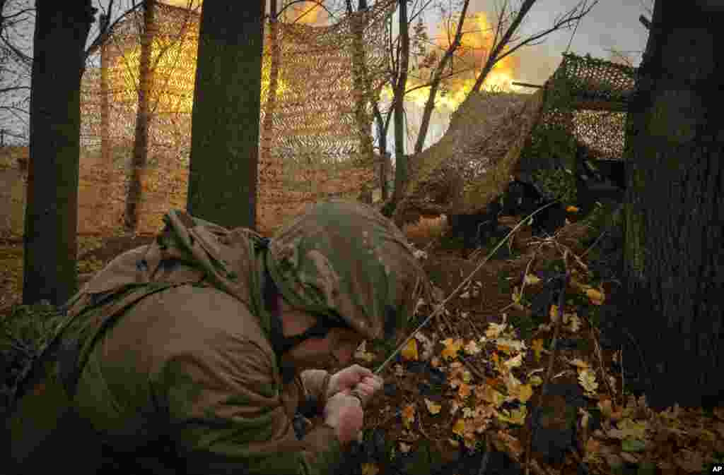 A serviceman of the 13th Brigade of the National Guard of Ukraine fires Giatsint-B gun towards Russian positions near Kharkiv, Ukraine.