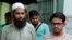 Suspected Muslim militants Saad-al-Nahin, right, and Masud Rana, who were arrested in the last week's killing of a secular blogger, stand before the media in Dhaka, Bangladesh, Friday, Aug. 14, 2015.