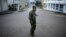 A Burmese policeman patrols a street in Namteuk, neighboring China's border town of Mangka in Burma's Wa State, September 3, 2009. 