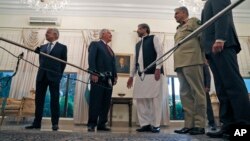 FILE - U. S. Secretary of State Rex Tillerson, center left, speaks with Pakistani Prime Minister Shahid Khaqan Abbasi, before their meeting at the Prime Minister's residence, Oct. 24, 2017, in Islamabad, Pakistan.