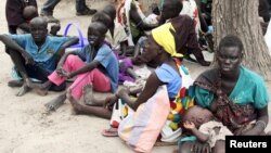  FILE - Residents displaced by fighting between government and rebel forces are seen at a World Food Program (WFP) outpost in Kuernyang Payam, South Sudan, May 2, 2015. 