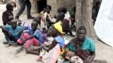 FILE - Residents displaced by fighting between government and rebel forces are seen at a World Food Program outpost in Kuernyang Payam, South Sudan May 2, 2015. 