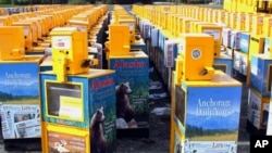 FILE - Hundreds of old newspaper sales boxes sit in a vacant lot near the former offices of the Alaska Dispatch News in Anchorage, Alaska, Sept. 11, 2017.