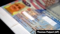 Paspor milik Dana Zzyym diletakkan di atas meja, Rabu, 27 Oktober 2021. Ini adalah paspor AS pertama yang dikeluarkan dengan penanda gender "X", pengakuan hak-hak orang yang tidak mengidentifikasi dirinya sebagai laki-laki atau perempuan. (Foto: AP/Thomas