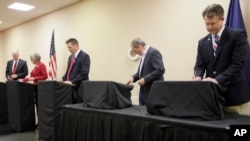 FILE - Senate candidates prepare for a GOP senatorial debate In Manhattan, Kan., May 23, 2020. David Lindstrom, left, Susan Wagle, second from left, Kris Kobach, middle, Bob Hamilton, second from right, and Roger Marshall, right, occupy the stage.