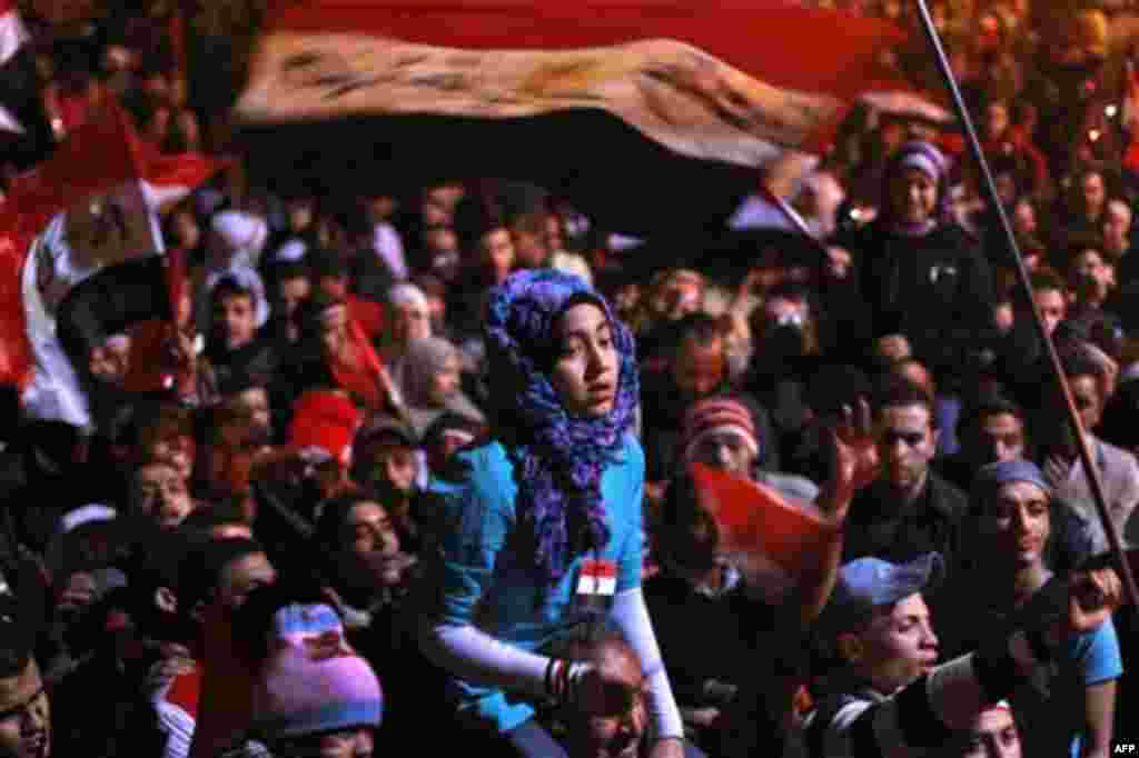 A young protester is carried on the shoulders of another, prior to the televised speech of Egyptian President Hosni Mubarak, in which protesters believed he would step down, at the continuing anti-government demonstration in Cairo, Egypt Thursday, Feb. 10