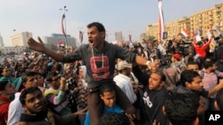 Egyptian protesters shout slogans against Defense Minister Gen. Abdel-Fattah el-Sissi as they march in Tahrir Square, in Cairo, Egypt, Nov. 19, 2013.