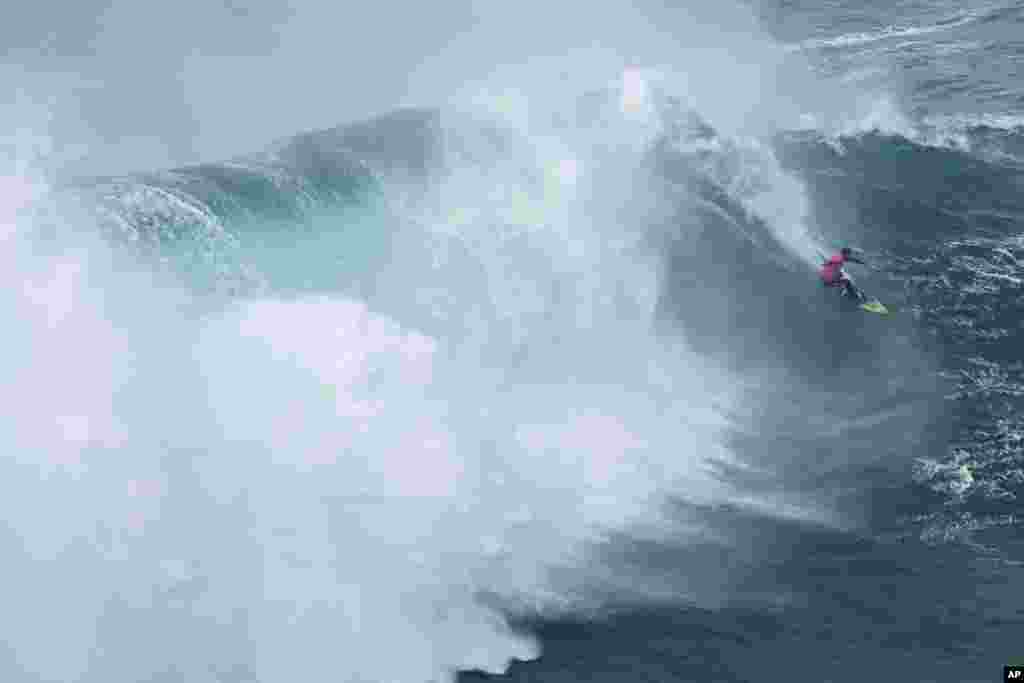 Lucas &quot;Chumbo&quot; Chianca from Brazil rides a wave during the Nazare Big Wave Challenge surfing tournament at Praia do Norte, or North Beach, in Nazare, Portugal.