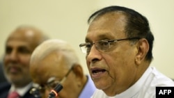 Sri Lanka's parliament speaker Karu Jayasuriya, at right, looks on at a meeting of MPs at the Parliament Building in Colombo, Nov. 2, 2018.