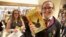 A young woman holds copies of the book from the play of "Harry Potter and the Cursed Child" parts One and Two at a bookstore in London, July 31, 2016.