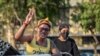 A pro-democracy protester flashes three-finger salute during a pro-democracy rally to mark UN Human Rights Day, Dec. 10, 2020 in Bangkok. The protesters marked the day with rallies calling for the abolition of Thailand’s strict royal defamation law.