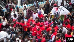 Musician turned politician Robert Kyagulanyi (C) is joined by other activists in Kampala, Uganda, July 11, 2018 in Kampala during a demonstration to protest a controversial tax on the use of social media.