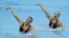 U.S.'s Mary Killman and Mariya Koroleva perform their duets technical routine during the FINA synchronized swimming London 2012 Olympic games qualification tournament at the Aquatics Centre in Olympic Park, London, April 18, 2012.