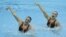 U.S.'s Mary Killman and Mariya Koroleva perform their duets technical routine during the FINA synchronized swimming London 2012 Olympic games qualification tournament at the Aquatics Centre in Olympic Park, London, April 18, 2012.