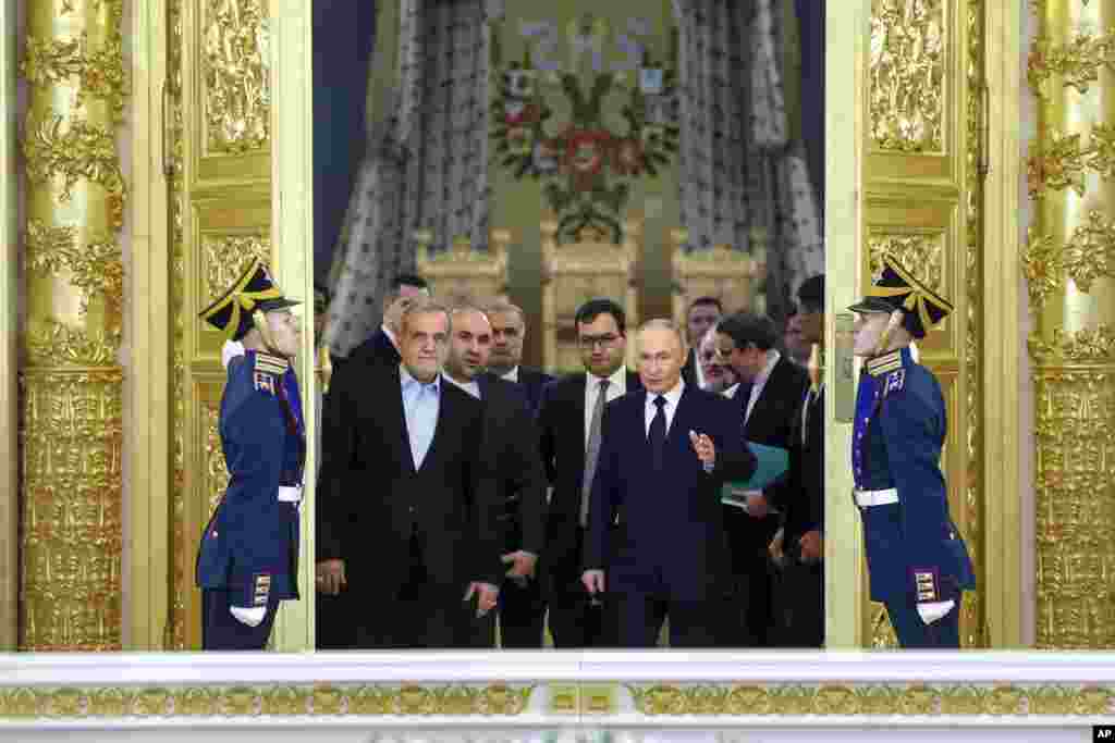 Iranian President Masoud Pezeshkian, center left, and Russian President Vladimir Putin, center right, arrive to attend a signing ceremony following their talks at the Kremlin in Moscow. (Vyacheslav Prokofyev, Sputnik, Kremlin Pool Photo via AP)