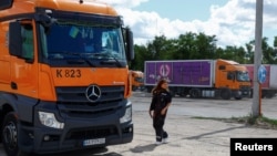 Driver Liliia Shulha walks to her truck at a compound of a logistics company, amid Russia's attack on Ukraine, in the village of Trebukhiv, Kyiv region, Ukraine Aug. 13, 2024.