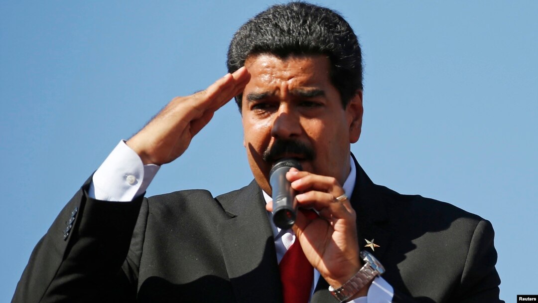 Venezuela's Vice President Nicolas Maduro speaks to thousands of supporters of Venezuela's late President Hugo Chavez as they wait to view his body in state at the Military Academy in Caracas March 7, 2013. Chavez, a former paratrooper, died on Tuesday ag