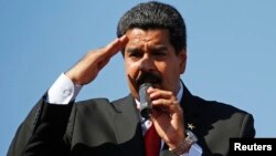 Venezuela's Vice President Nicolas Maduro speaks to thousands of supporters of Venezuela's late President Hugo Chavez as they wait to view his body in state at the Military Academy in Caracas March 7, 2013. Chavez, a former paratrooper, died on Tuesday ag