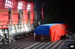 FILE - The Russian flag-covered coffin of Russian pilot Lt. Col. Oleg Peshkov is shown inside a Russian air force transport plane at Esenboga Airport in Ankara, Turkey, Nov. 30, 2015. He was killed when Turkish F-16s shot his plane down.