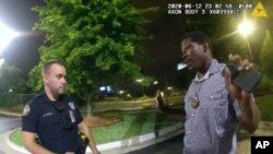 This screen grab taken from body camera video provided by the Atlanta Police Department shows Rayshard Brooks speaking with Officer Garrett Rolfe in the parking lot of a Wendy's restaurant, late Friday, June 12, 2020, in Atlanta.