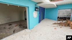 FILE - Sand washed ashore by the surge of Hurricane Helene fills a house in Treasure Island, Florida, Oct. 2, 2024.