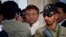Pakistan's former president and military ruler Pervez Musharraf, center, leaves after appearing in court in Rawalpindi, Pakistan, April 17, 2013. 