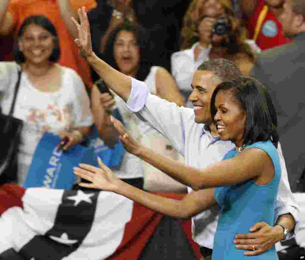 President Barack Obama and his wife, Michelle, wave to the crowd during a campaign rally at Virginia Commonwealth University in Richmond, Virginia, May 5, 2012. (AP)