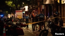 Police investigate the scene of a mass shooting in the Sixth Street entertainment district area of Austin, Texas, June 12, 2021. 