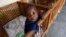FILE - Imani, an abandoned child at Don Bosco Ngangi community center in Goma, North Kivu region, Democratic Republic of Congo, Aug. 6, 2013.Congo became a favored international adoption destination in recent years because it has more than 4 million orphaned children.