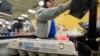 FILE - Cashier Josh Jimenez rings up eggs for sale at a grocery store, Feb. 7, 2025, in Dallas.