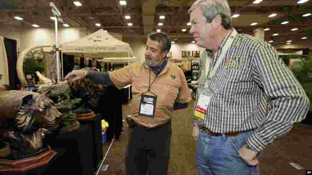 Hunters buy special permits from some African governments to hunt large wildlife on a restricted basis. Fees sometimes help fund animal conservation progrems. When the Dallas Safari Club auctioned a permit to hunt an endangered black rhino, the FBI investigated death threat claims. The club&#39;s executive director, Ben Carter, (right), was photographed with a wildlife artist at the club&#39;s January, 2014 show.