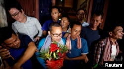 Members of the dissolved opposition Cambodia National Rescue Party (CNRP), pose for a picture after they were released from jail by King Norodom Sihamoni's pardon in Phnom Penh, Cambodia, Aug. 28, 2018. 