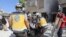 Members of the Syrian Civil Defense carry away a body retrieved from the rubble following a reported regime airstrike on the village of Kafriya, in Syria's Idlib province, July 13, 2019.