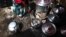 FILE - A woman adjusts the charcoal in a stove next to cooking pots at a village about 30 km (19 miles) south of South Sudan's capital Juba, June 21, 2013. 