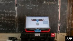 A voting machine sits on a table during a training for electoral agents from the Independent National Electoral Commission (CENI) at a voting center in Lubumbashi on December 19, 2023, on the eve of Democratic Republic of Congo's presidential and general 