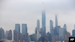 The Navy hospital ship USNS Comfort passes the Manhattan skyline on its way to docking in New York, March 30, 2020. 