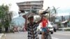 A boy carries metal sheets that were blown away from houses in the winds of Typhoon Goni in Albay province, central Philippines on Nov. 3, 2020.