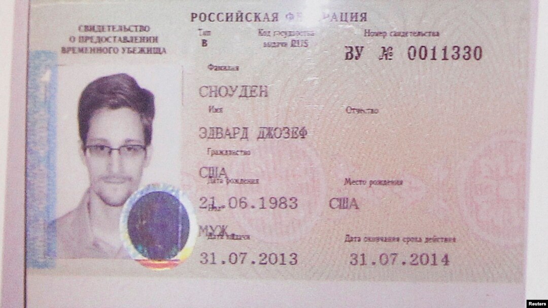 FILE - Former U.S. intelligence contractor Edward Snowden's refugee document granted by Russia is seen during a news conference in Moscow August 1, 2013. 