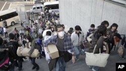 Evacuees from Futaba, a town near the tsunami-crippled Fukushima Dai-ichi nuclear plant in Fukushima Prefecture, arrive their new evacuation shelter at Saitama Super Arena in Saitama, near Tokyo, Japan, March 19, 2011