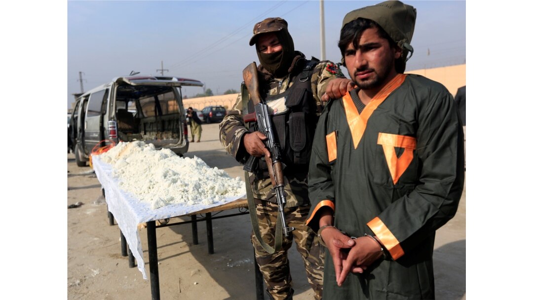 FILE - A captured Taliban insurgent is presented to the media after he was detained with car explosive devices in Jalalabad, Afghanistan, Dec. 10, 2019.