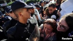 Police officers try to disperse demonstrators during a protest in Algiers, Algeria, November 28, 2019.