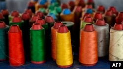 This photo taken on Feb. 20, 2025, shows rolls of thread at a clothing sewing workshop in Guangzhou, China. The Trump administration and Congress are looking to throttle methods some Chinese businesses use to avoid paying the higher tariffs imposed on goods from their country.