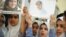 Students hold pictures of schoolgirl Malala Yousufzai, who was shot by the Taliban, during a tribute at the Pakistani Embassy in Abu Dhabi October 15, 2012. 
