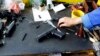 A weapons designer picks up a prototype of a handgun at the manufacturing hall in the "Zastava Arms" weapons factory in the Serbian town of Kragujevac, some 137km (85 miles) from capital Belgrade, May 8, 2013.