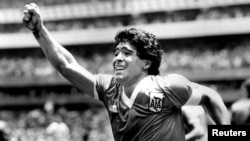 FILE - Argentinian star Diego Maradona raises his arm in the air after scoring his game-winning goal against England in their World Cup semi final in Mexico, June 22, 1986. 