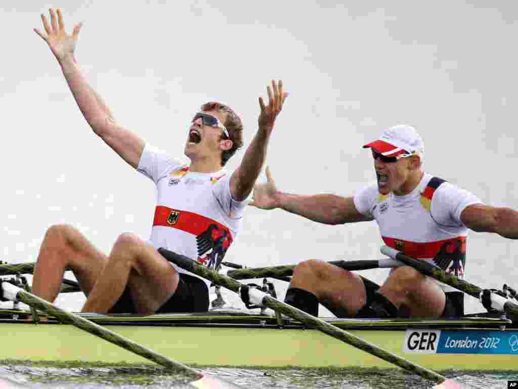 Germany's Phillipp Wende and Karl Schulze celebrate after winning the gold medal for the men's quadruple rowing sculls.