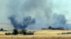 FILE - Smoke from a U.S.-led airstrike rises over the outskirts of Tal Abyad, Syria, in this photo taken in Akcakale, Sanliurfa province, southeastern Turkey from the Turkish side of the border between Turkey and Syria, June 14, 2015.