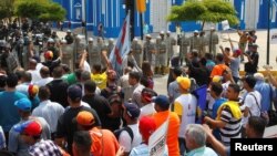 Opposition supporters argue with Venezuelan National Guards during a rally in support of Juan Pablo Guanipa, elected governor of Zulia state, in Maracaibo, Venezuela, Oct. 24, 2017.